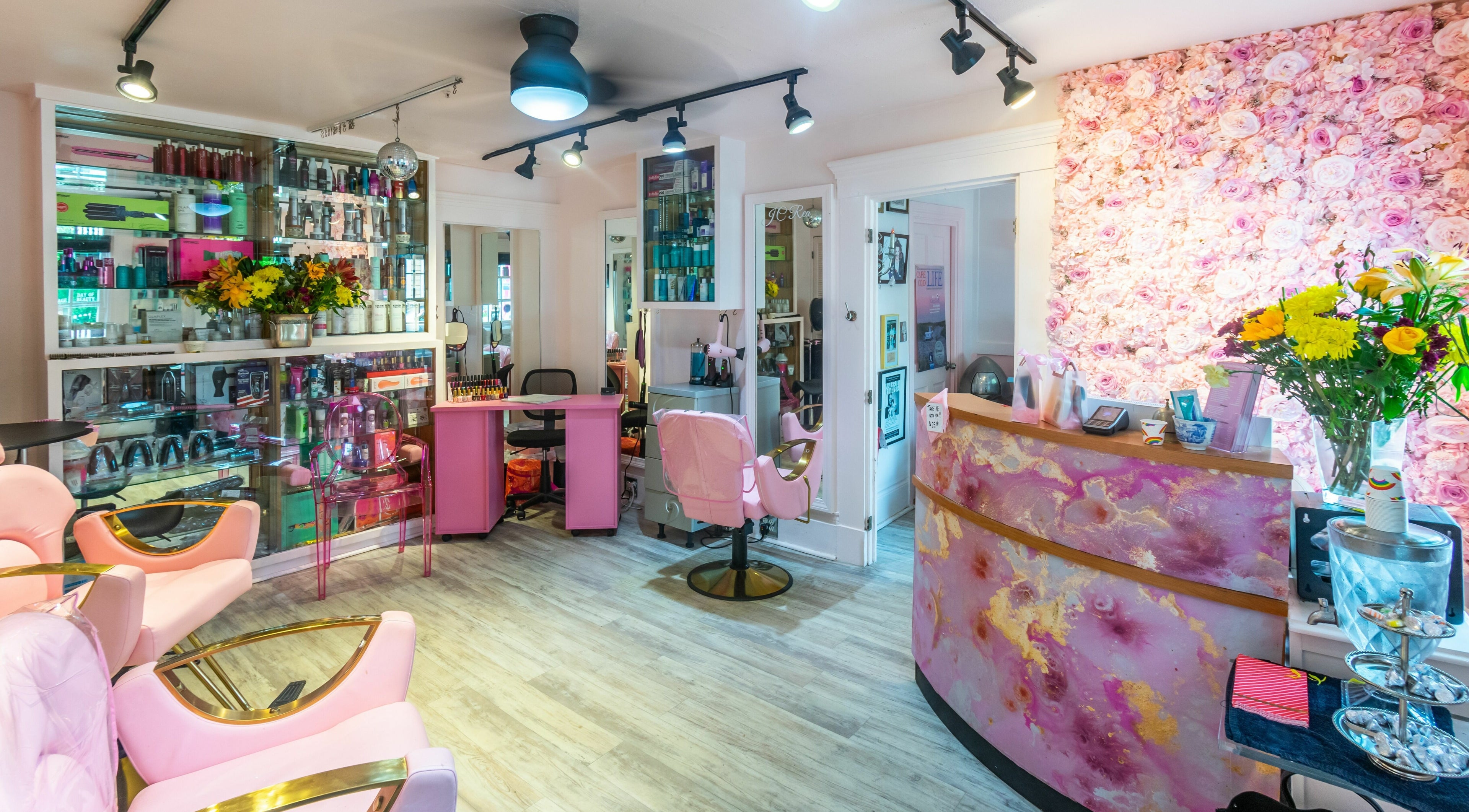 Vibrant interior at West End Salon & Spa in Provincetown, Massachusetts, US, featuring pink decor and floral accents.