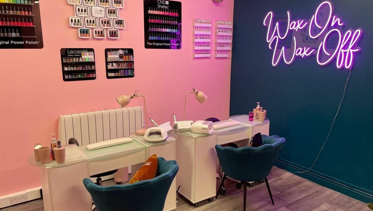 Modern nail salon at Gems Beauty in Swindon, England, GB with cozy chairs and vibrant wall decor.