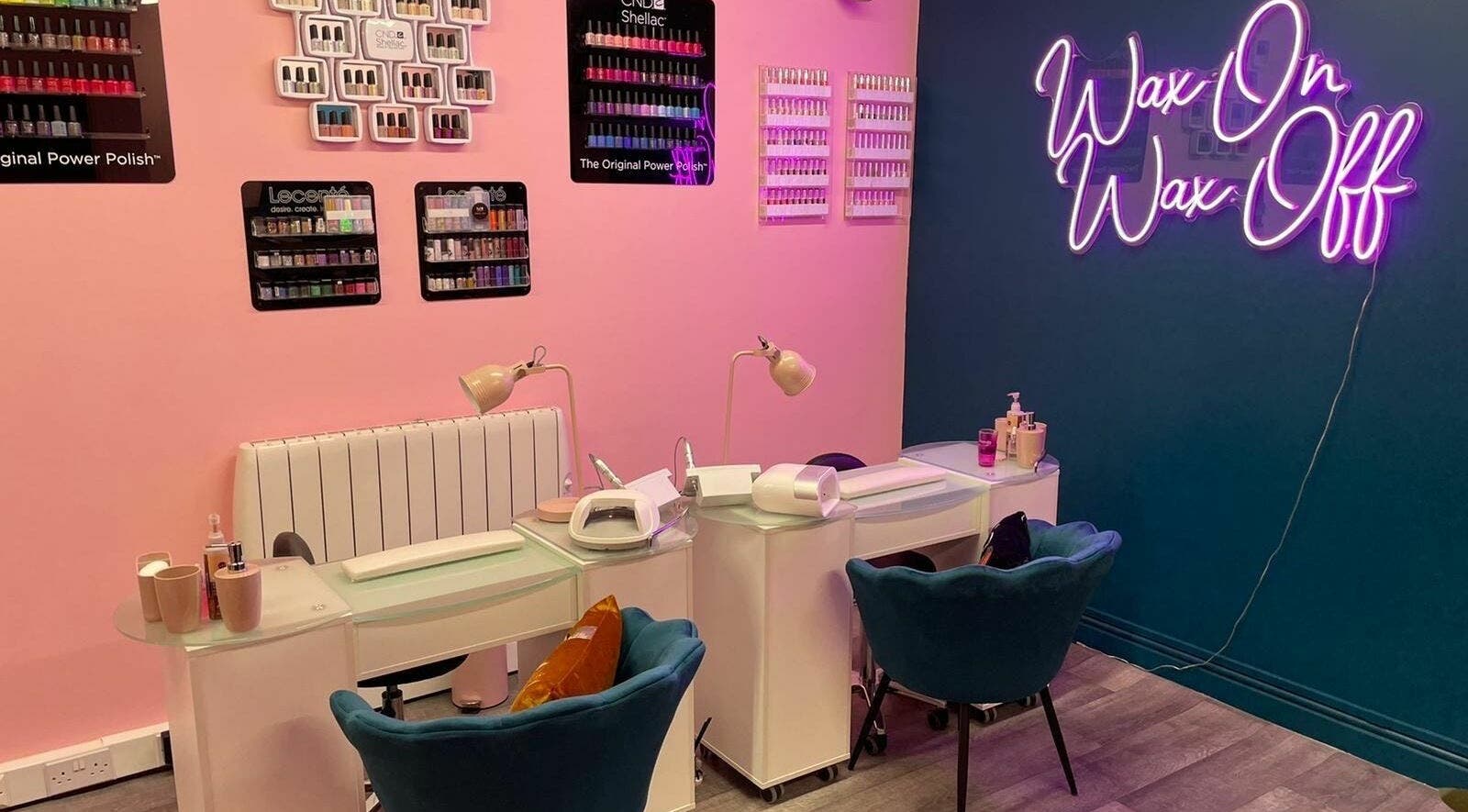 Modern nail salon at Gems Beauty in Swindon, England, GB with cozy chairs and vibrant wall decor.