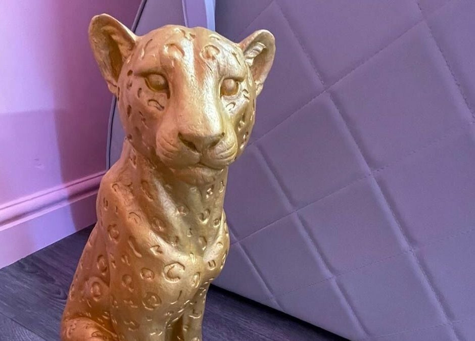 Golden panther statue inside Gems Beauty in Swindon, England, GB, creating a luxurious atmosphere.