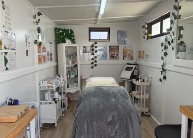 Cozy treatment room at H.O.T - House of Trend in Cape Town, Western Cape, ZA, featuring a comfortable bed and skincare products.
