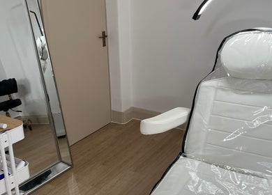 Sleek beauty treatment room at LR Skin & Aesthetics, Leicester, England, GB, featuring a comfortable chair and mirror.