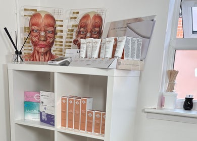 Product display at LR Skin & Aesthetics, Leicester, England, GB featuring skincare items and anatomical charts.