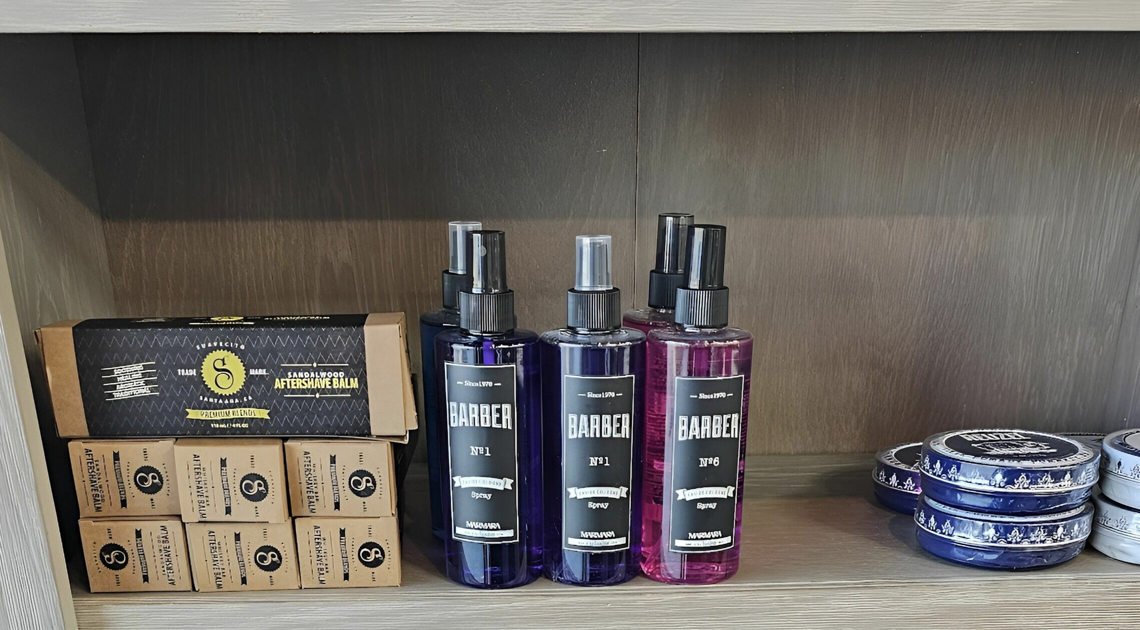Lux Barbershop grooming products on display in Alpharetta, Georgia, US, featuring aftershave and sprays.