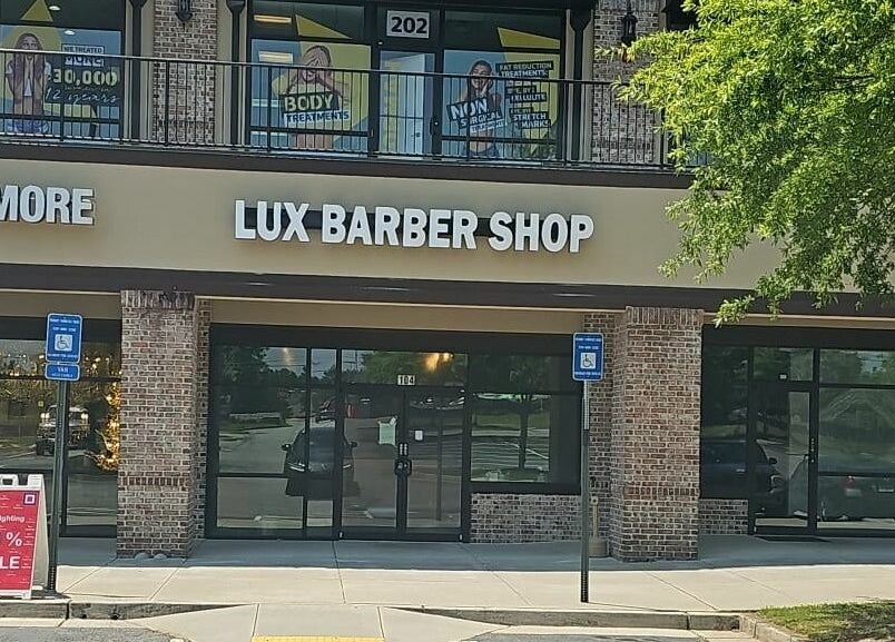 Lux Barbershop facade at Alpharetta, Georgia, US, showcasing sophisticated storefront design.