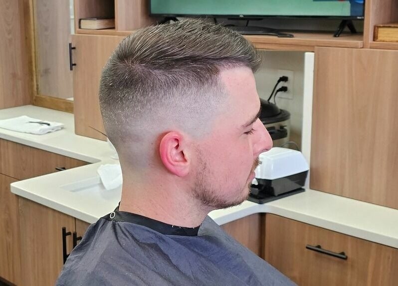 Client with a fresh haircut at Lux Barbershop, Alpharetta, Georgia, US, showcasing trendy style.