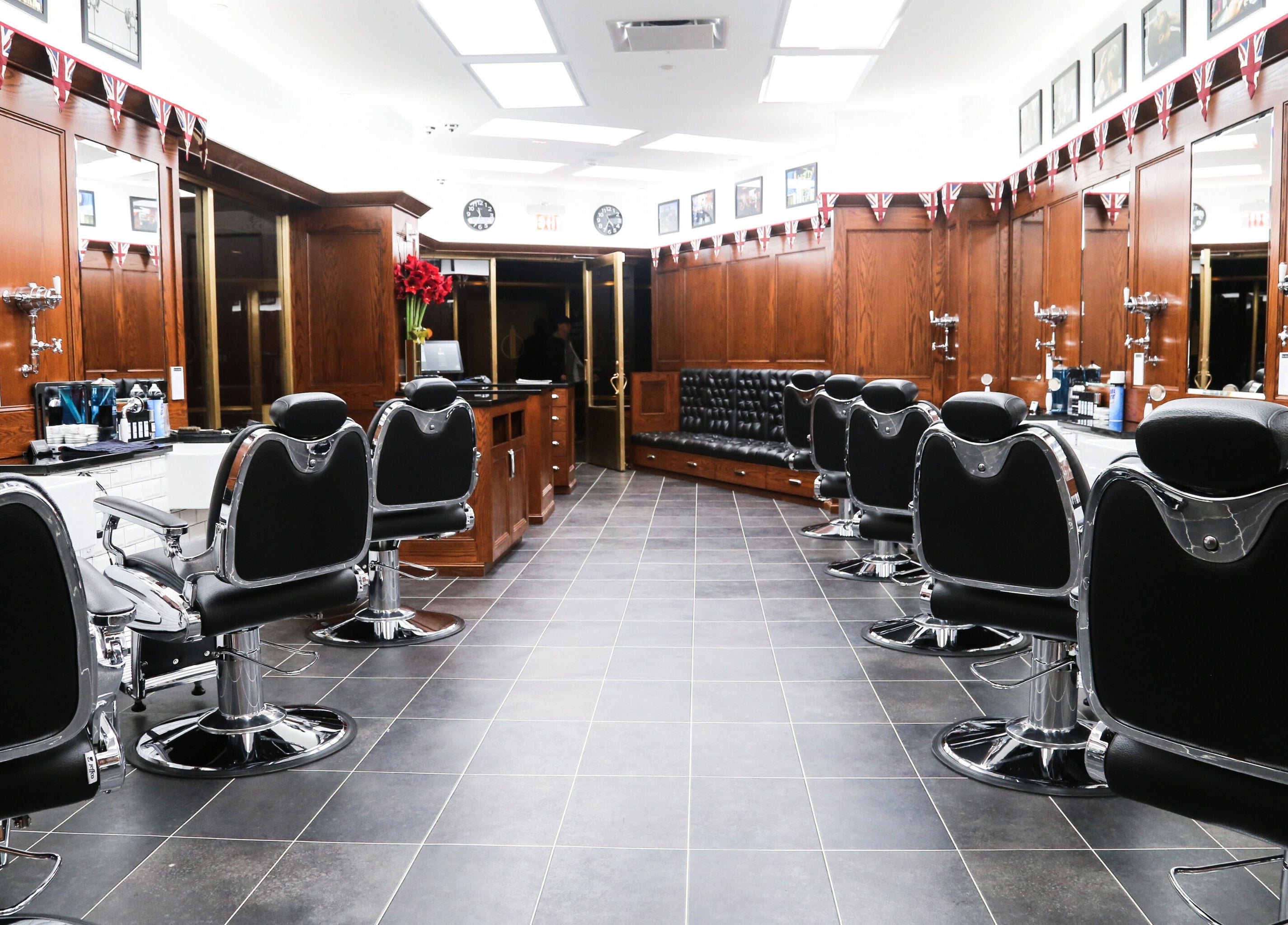 Stylish interior of Pall Mall Barbers NYC showcasing classic barber chairs, New York, New York, US.