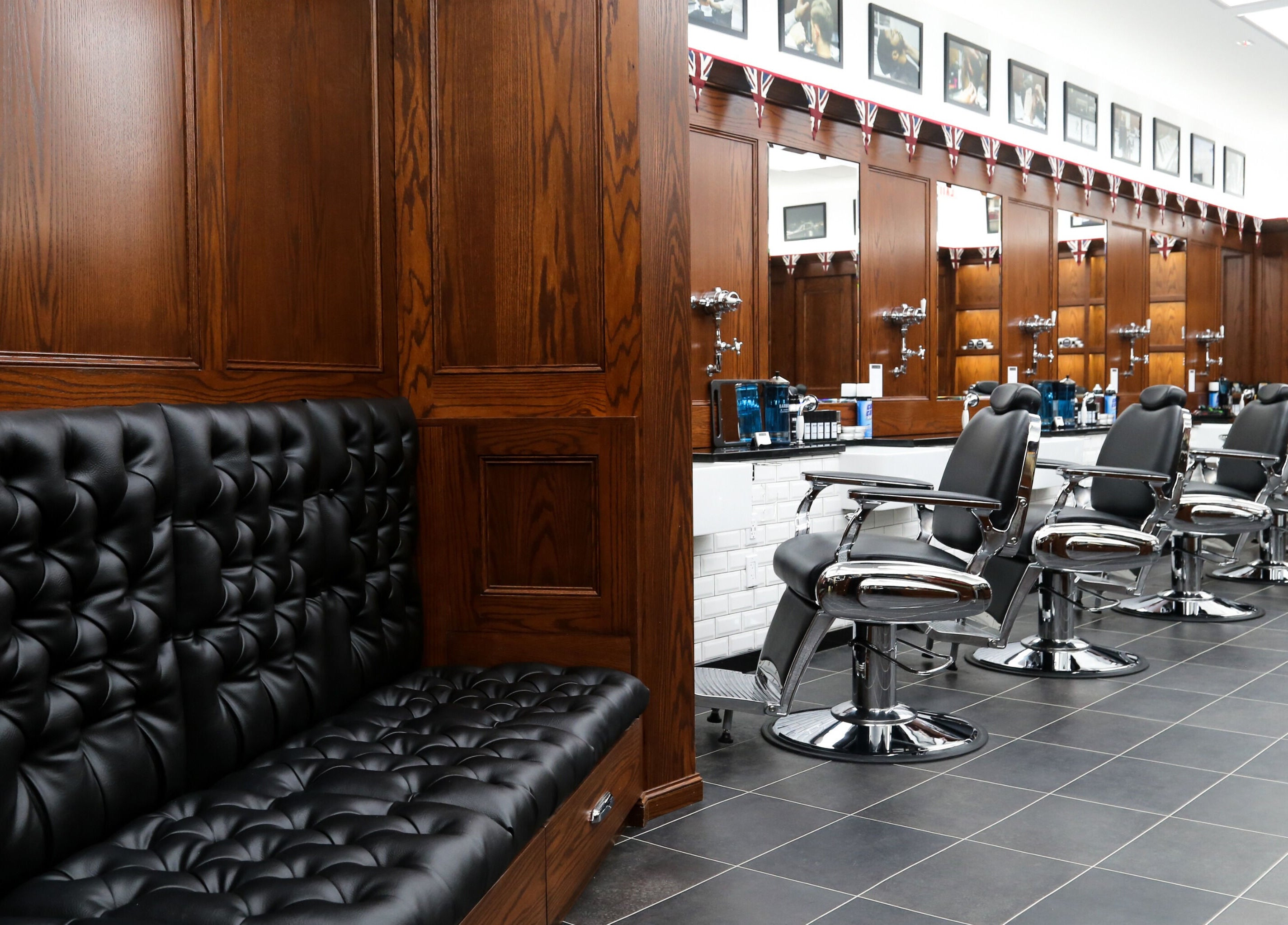 Elegant interior of Pall Mall Barbers NYC with leather seating and barber chairs, New York, New York, US.