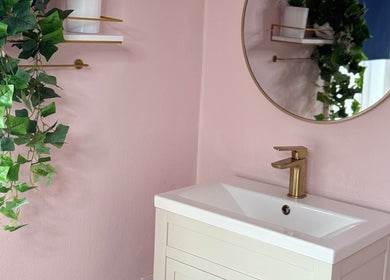 Elegant vanity with mirror at Serene Aesthetic Clinic, Poole, England, GB, adorned with lush greenery.