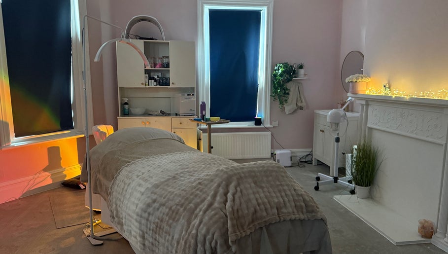Cozy treatment room at Serene Aesthetic Clinic in Poole, England, GB with soft lighting and comfortable bed.