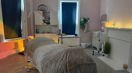 Cozy treatment room at Serene Aesthetic Clinic in Poole, England, GB with soft lighting and comfortable bed.