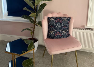 Elegant seating area at Serene Aesthetic Clinic, Poole, England, GB with pink chair and plant.