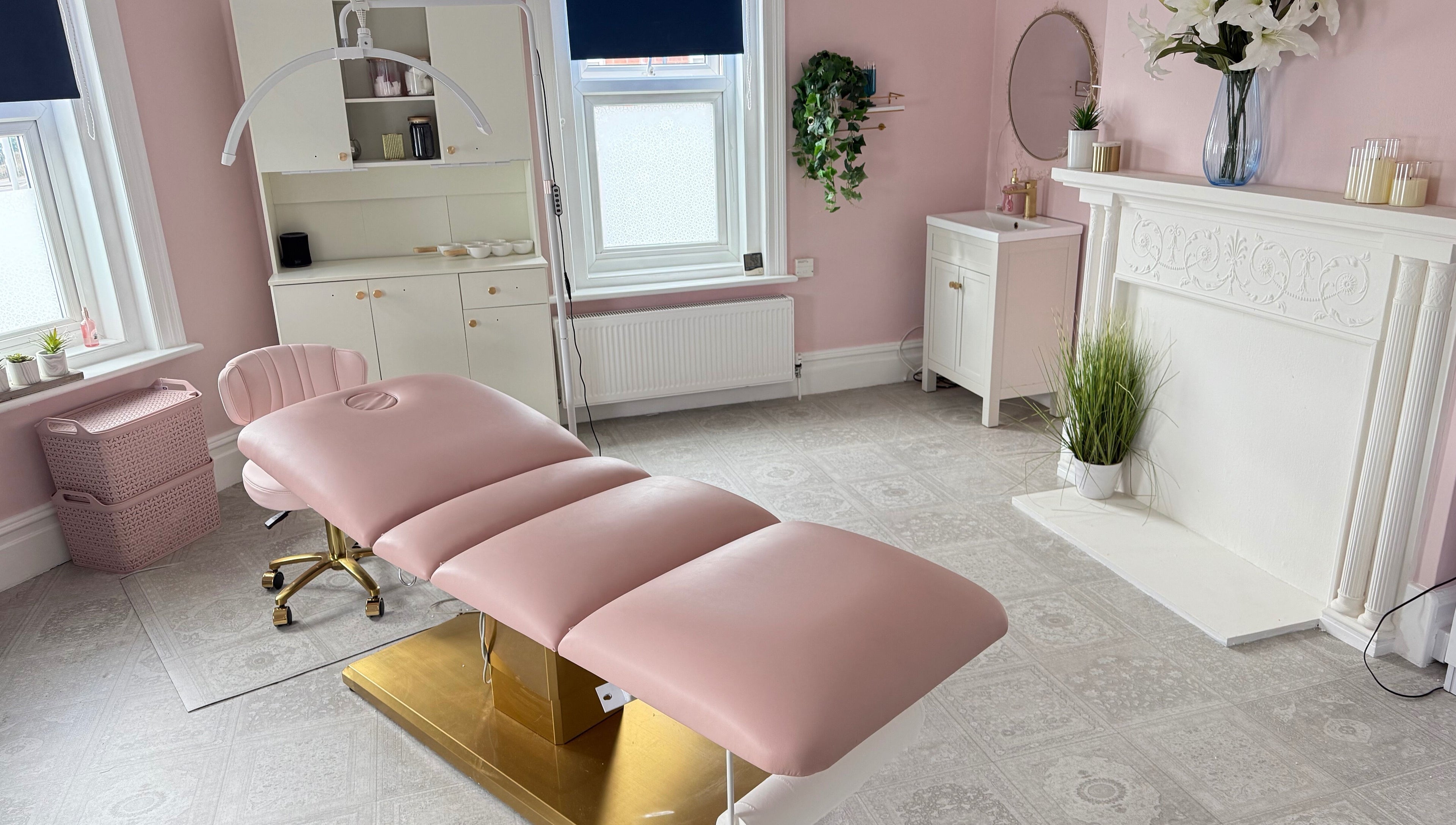 Elegant treatment room at Serene Aesthetic Clinic, Poole, England, GB with a pink recliner and soft decor.