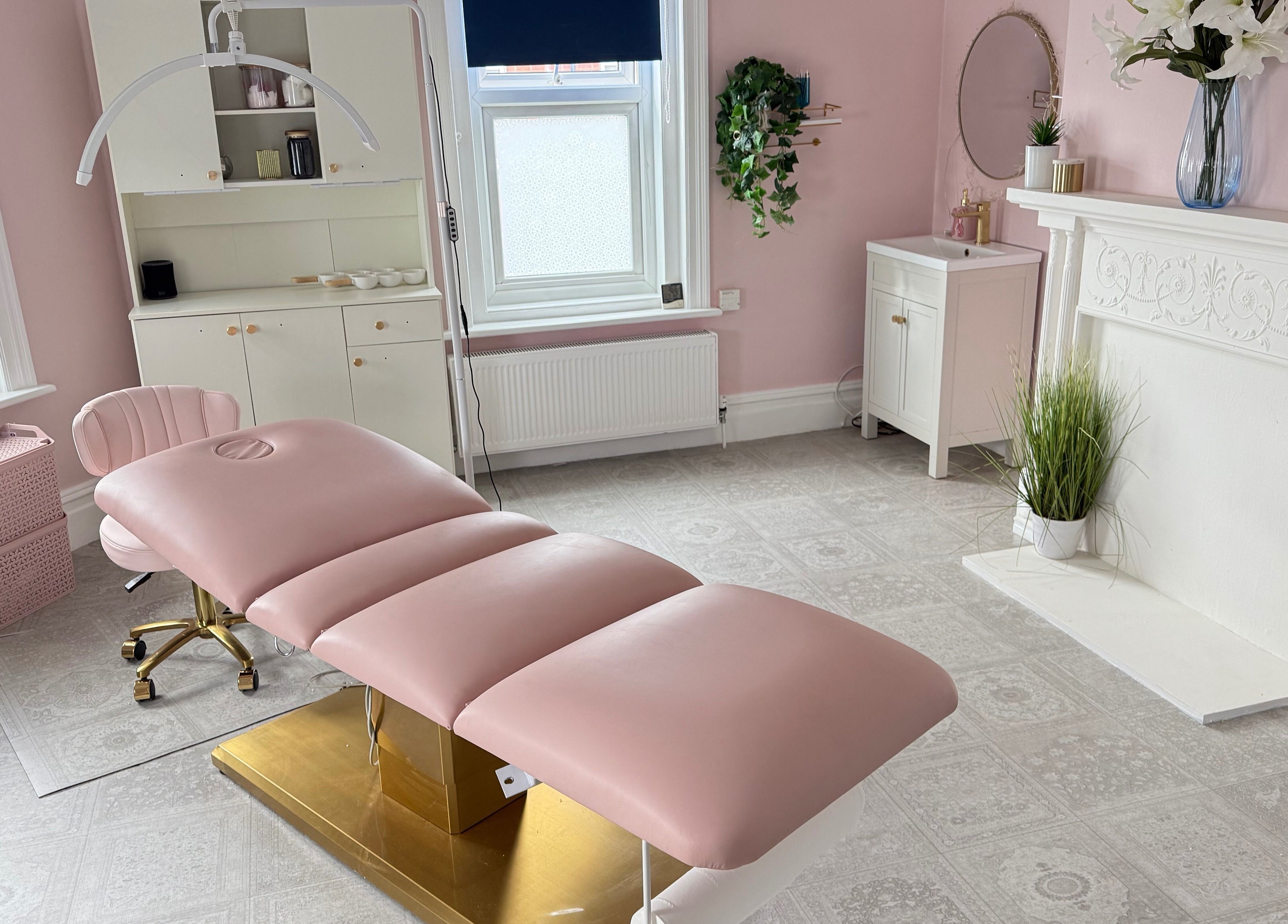 Elegant treatment room at Serene Aesthetic Clinic, Poole, England, GB with a pink recliner and soft decor.