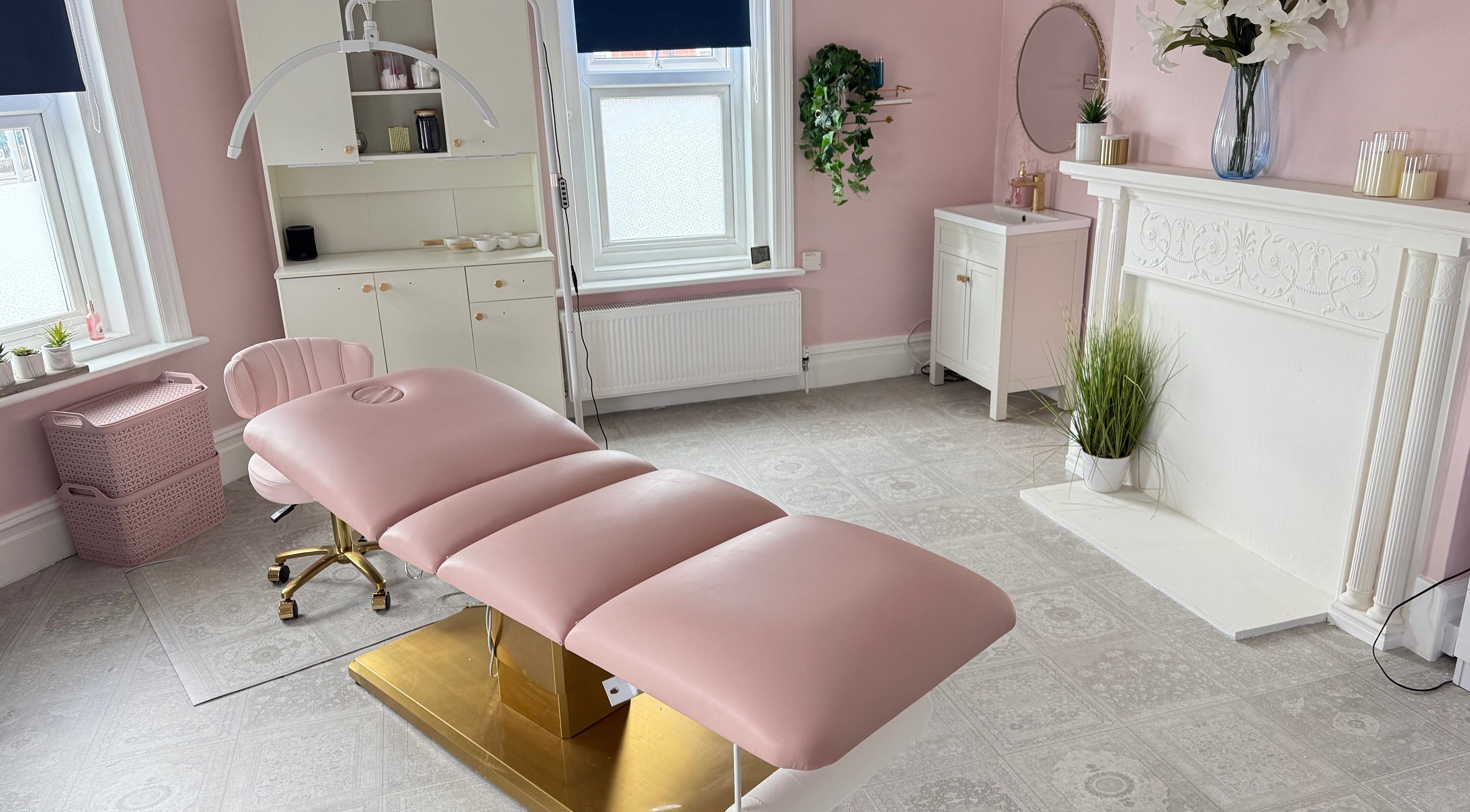 Elegant treatment room at Serene Aesthetic Clinic, Poole, England, GB with a pink recliner and soft decor.