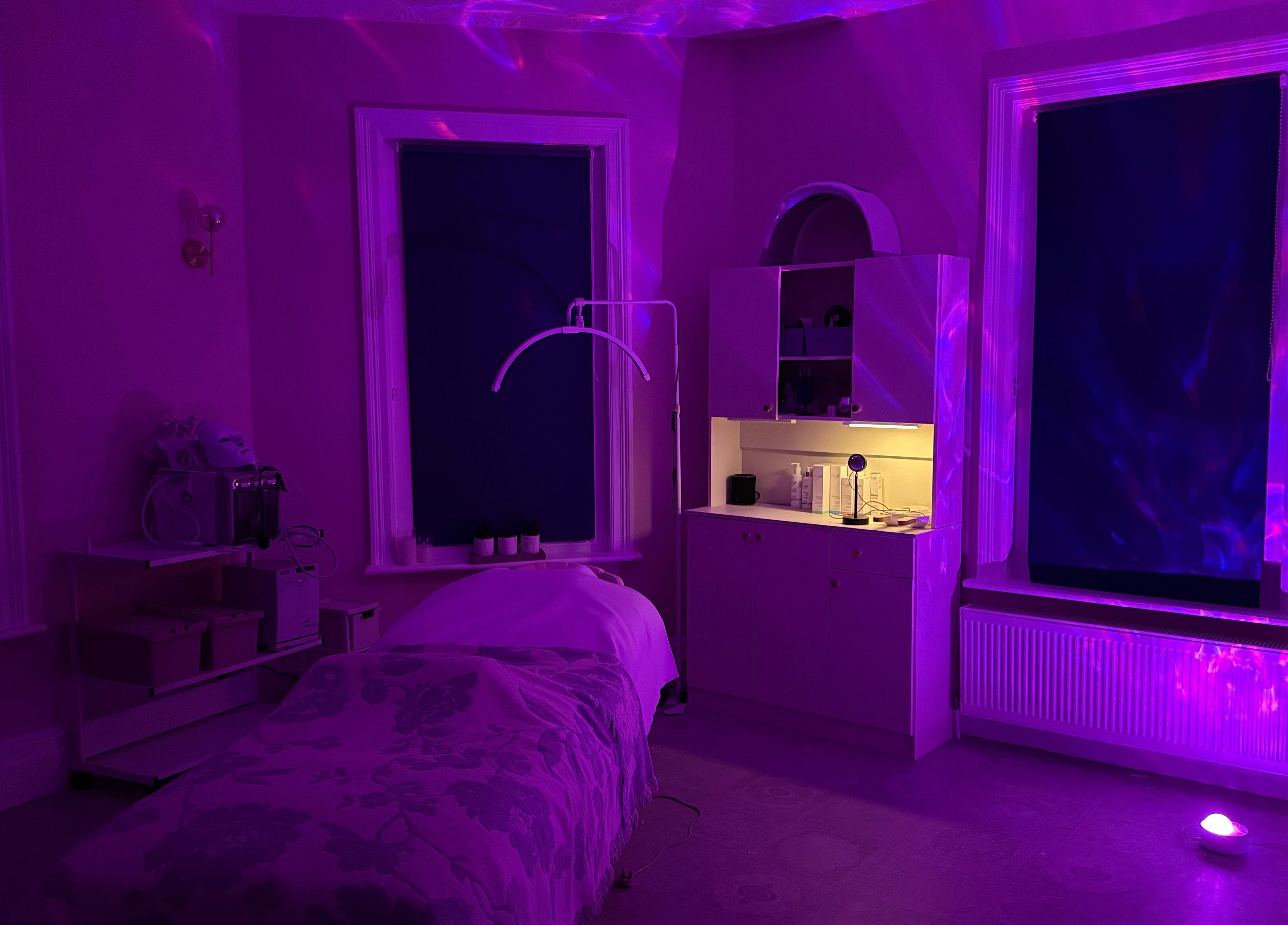 Relaxing treatment room with ambient purple lighting at Serene Aesthetic Clinic in Poole, England, GB.