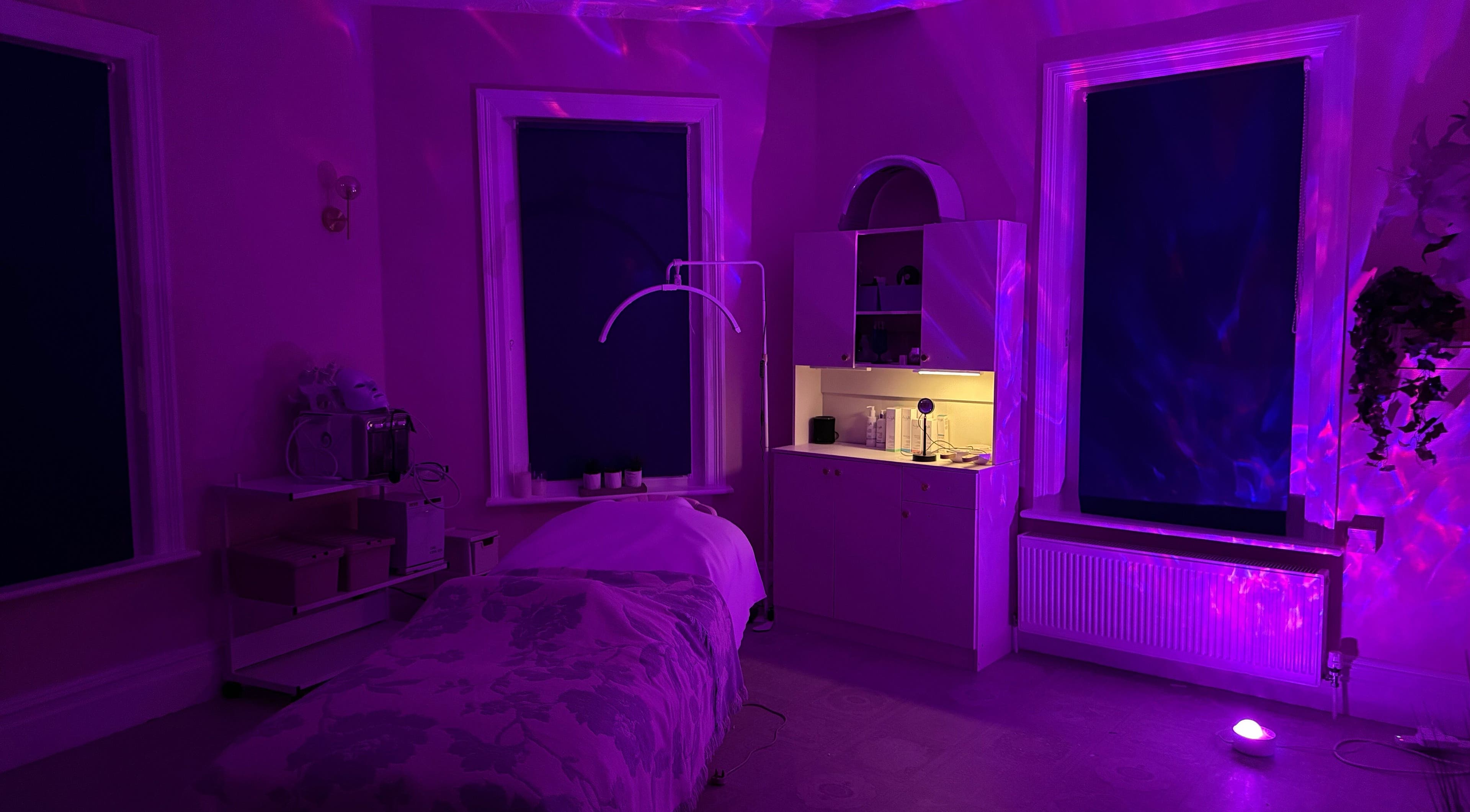 Relaxing treatment room with ambient purple lighting at Serene Aesthetic Clinic in Poole, England, GB.