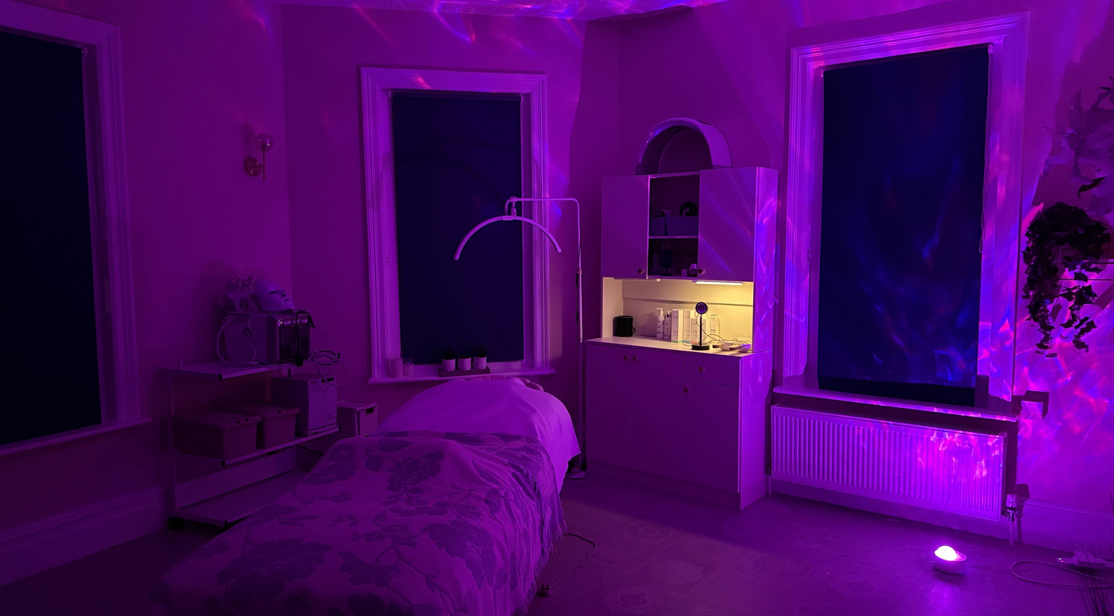 Relaxing treatment room with ambient purple lighting at Serene Aesthetic Clinic in Poole, England, GB.
