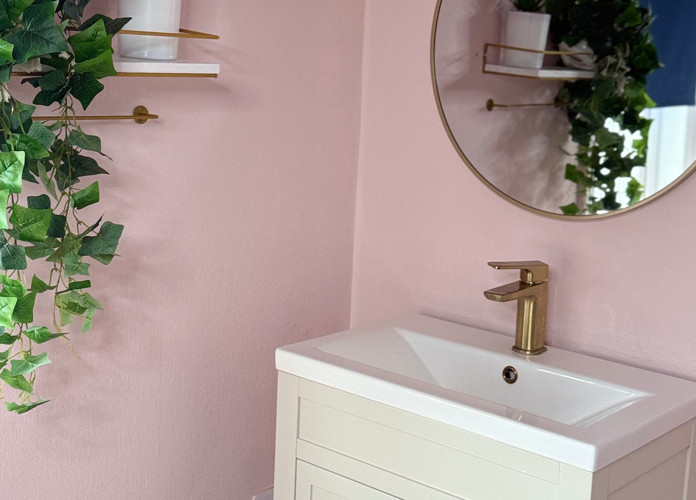 Elegant bathroom vanity at Serene Aesthetic Clinic, Poole, England, GB, with pink walls and decorative plants.