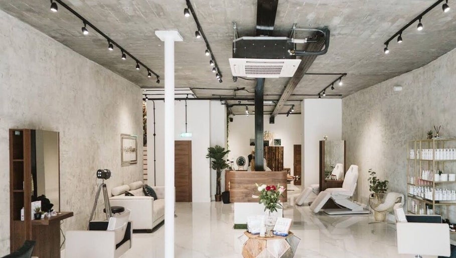 Modern interior of Saheed Hair Studio@ Hair Bian in London, England, GB showcasing sleek design and comfortable seating.