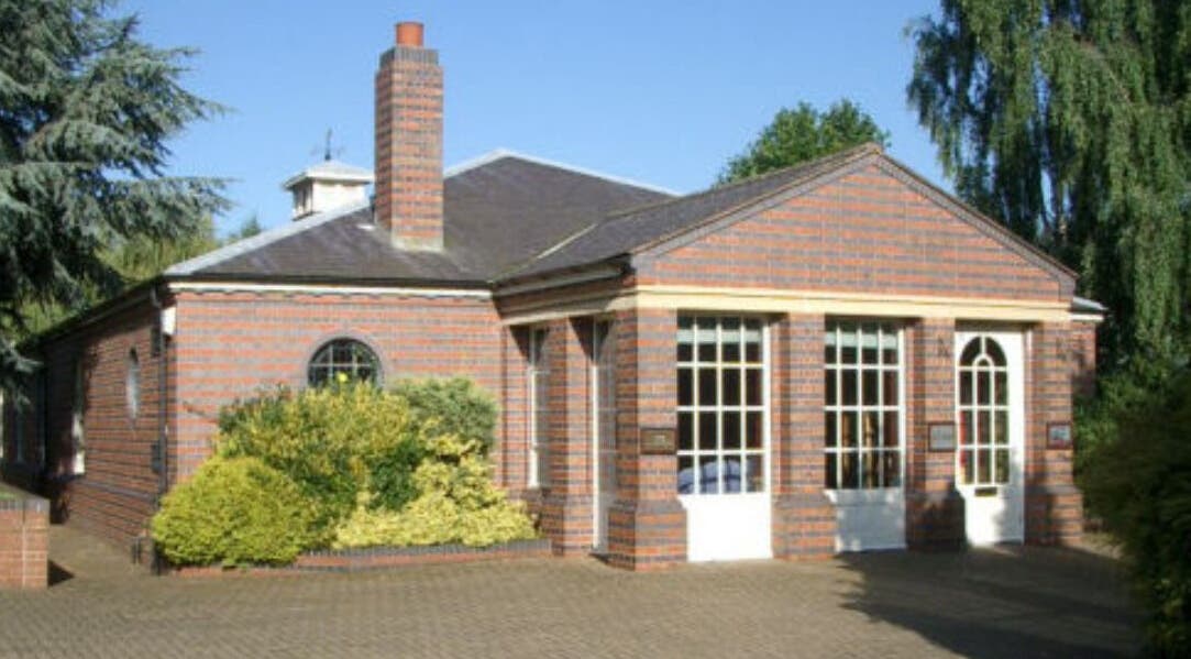 Brick building of Caroline at Ritual Therapies in Birmingham, England, GB, surrounded by lush greenery.