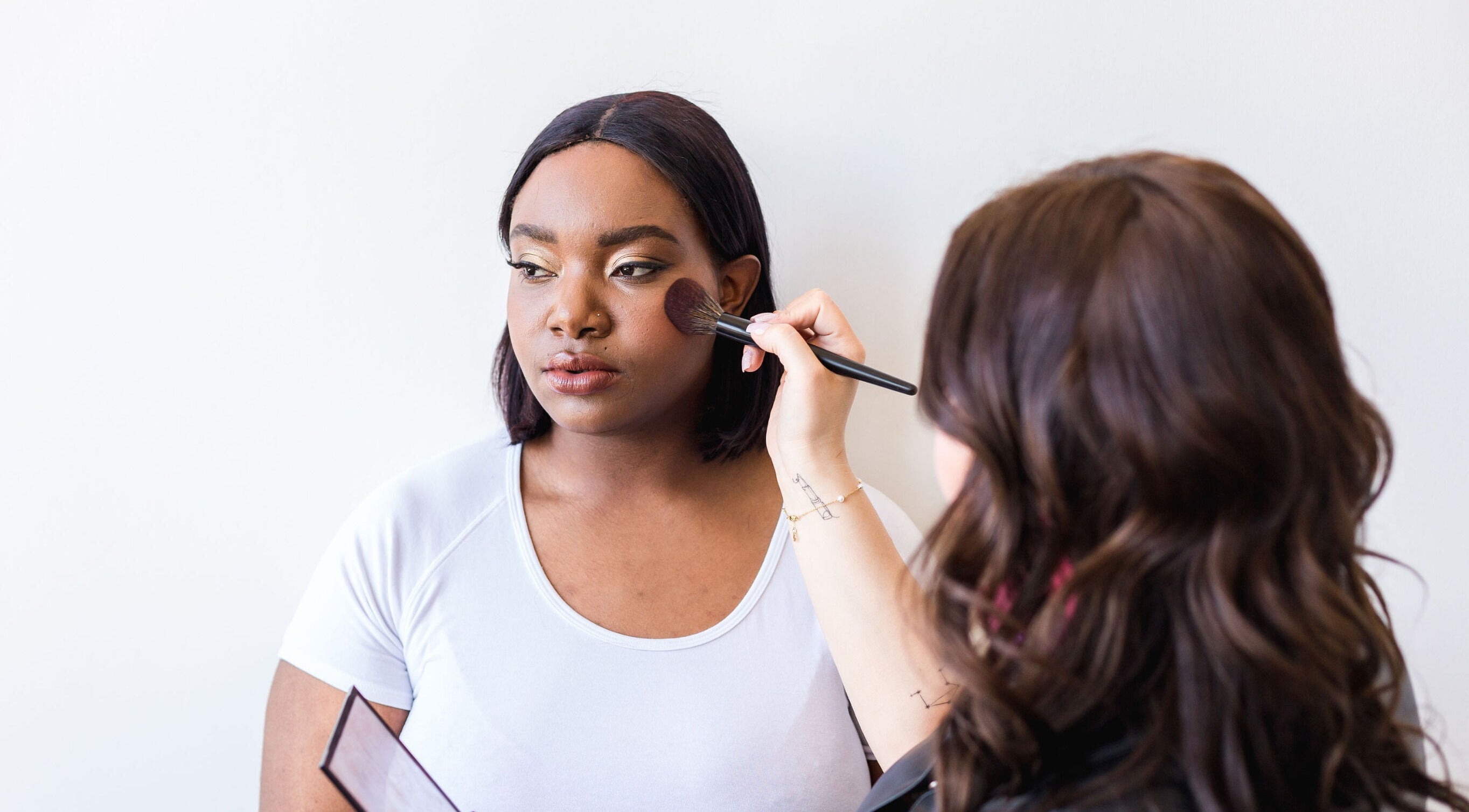 Makeup artist applying blush at Morgan Sarah Beauty, Whitby, Ontario, CA.