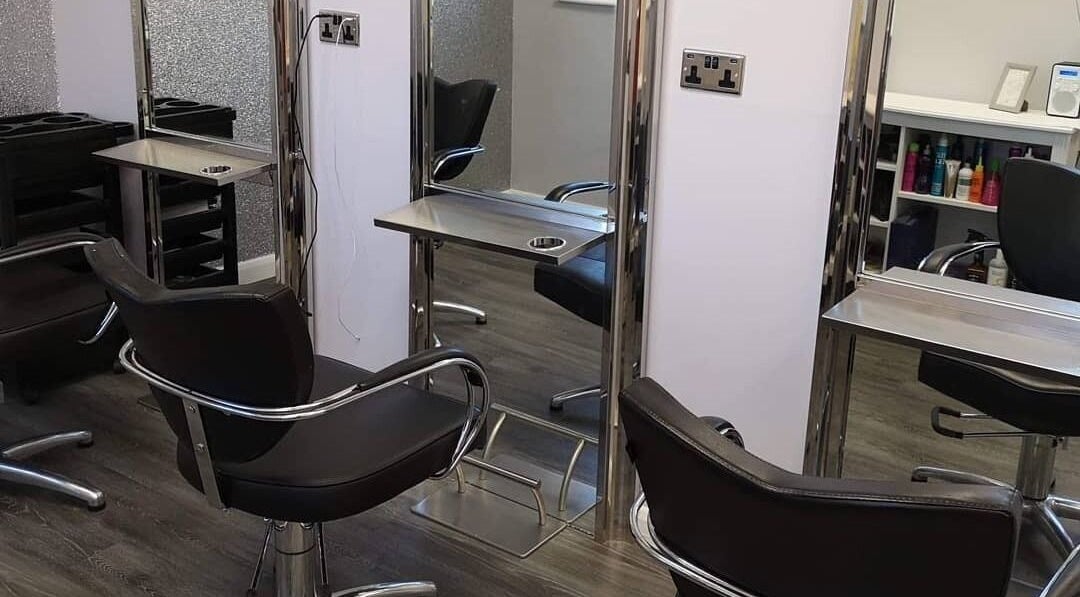 Modern salon interior at House of Hair, Nottingham, England, GB, showcasing sleek styling chairs and mirrors.