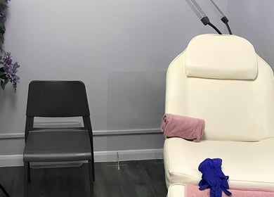 Relaxing treatment room at House of Hair, Nottingham, England, GB, featuring a white chair and floral decor.
