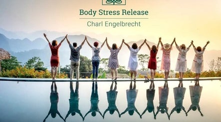 Uplifting group at Hartenbos Body Stress Release, Mossel Bay, Western Cape, ZA, during a serene sunset.