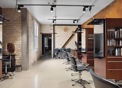 Stylish salon interior at Revival Hair Design in Huntly, Waikato, NZ, featuring modern chairs and mirrors.