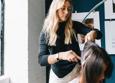 Stylist at Salon Chatsworth Road E5 creating a hairstyle in London, England, GB.