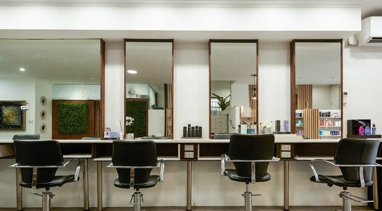 Modern salon interior at Second Avenue Hair and Beauty Camberwell, Melbourne, Victoria, AU with black chairs.