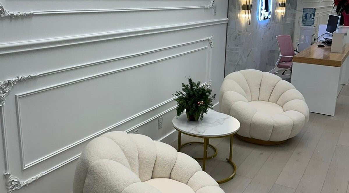 Elegant waiting area at BellaDonna Aesthetics & Wellness DT Calgary, Calgary, Alberta, CA with plush seating.