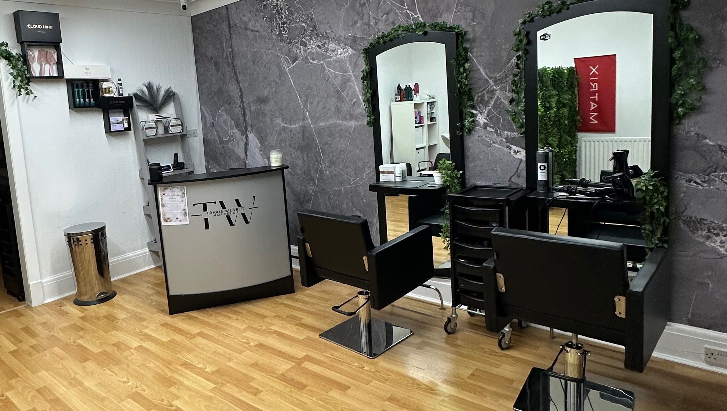 Modern interior of Travis Webber Hair Design salon in Lytham St Annes, England, GB with sleek chairs and mirrors.