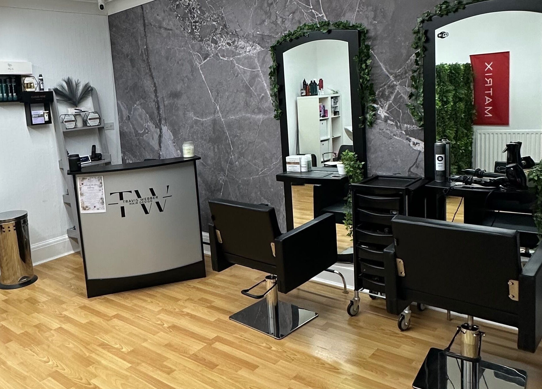 Modern interior of Travis Webber Hair Design salon in Lytham St Annes, England, GB with sleek chairs and mirrors.