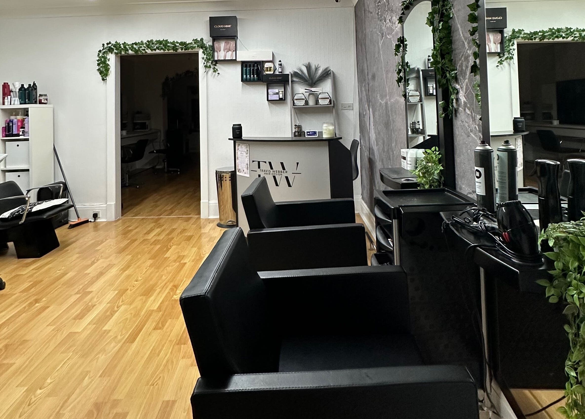 Modern interior of Travis Webber Hair Design, Lytham St Annes. Sleek chairs, mirrors, and plants create a calm ambiance.