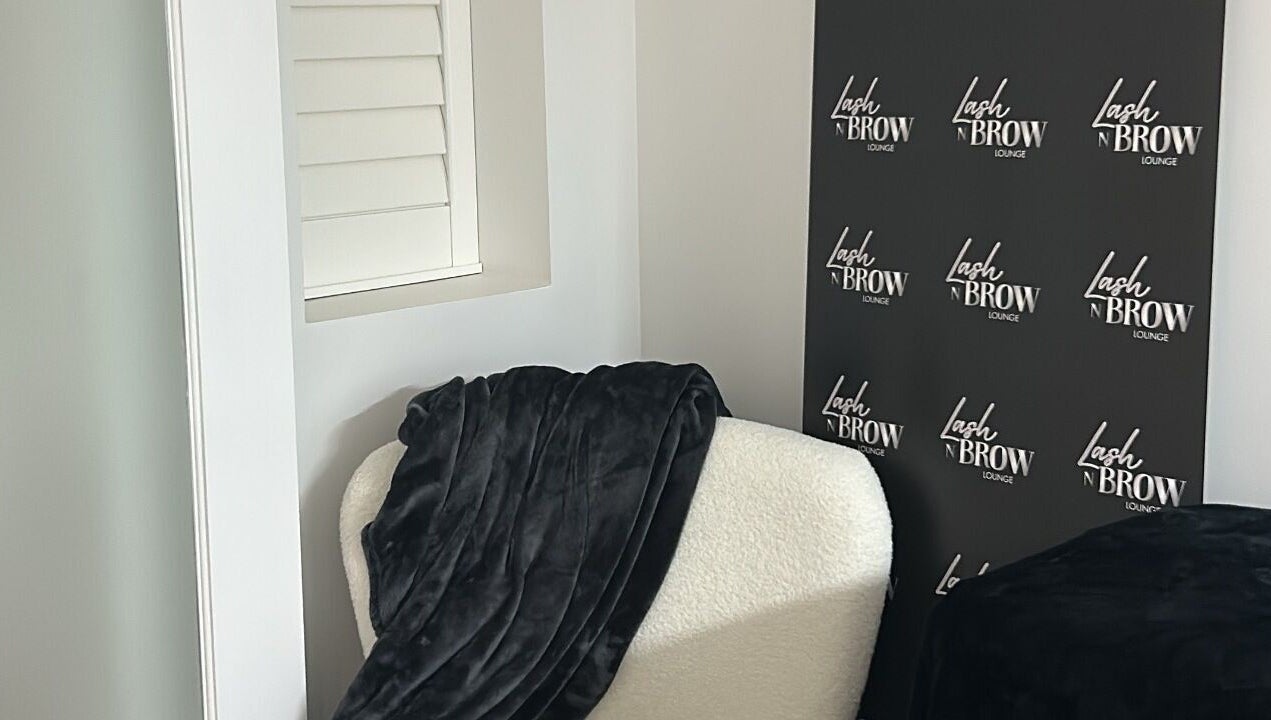 Elegant lounge area at Lash N Brow Lounge, Melbourne, Victoria, AU with plush seating and branded decor.