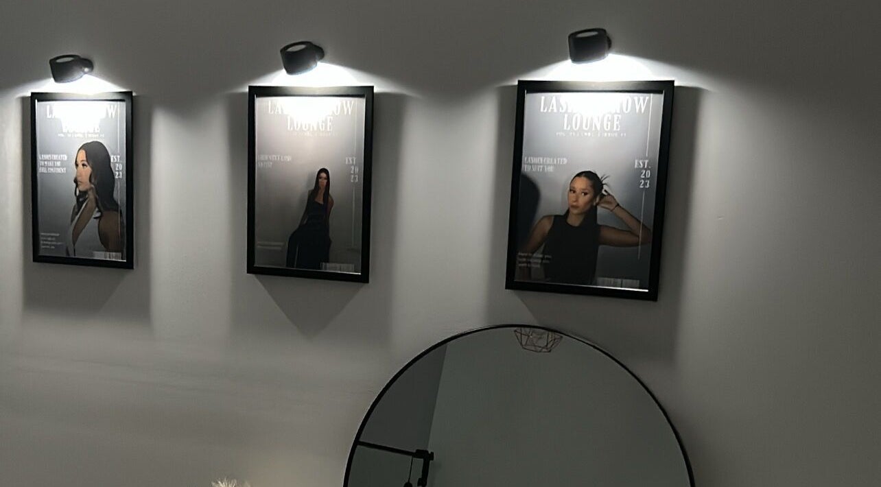 Elegant framed posters at Lash N Brow Lounge, Melbourne, Victoria, AU enhance the chic venue style.
