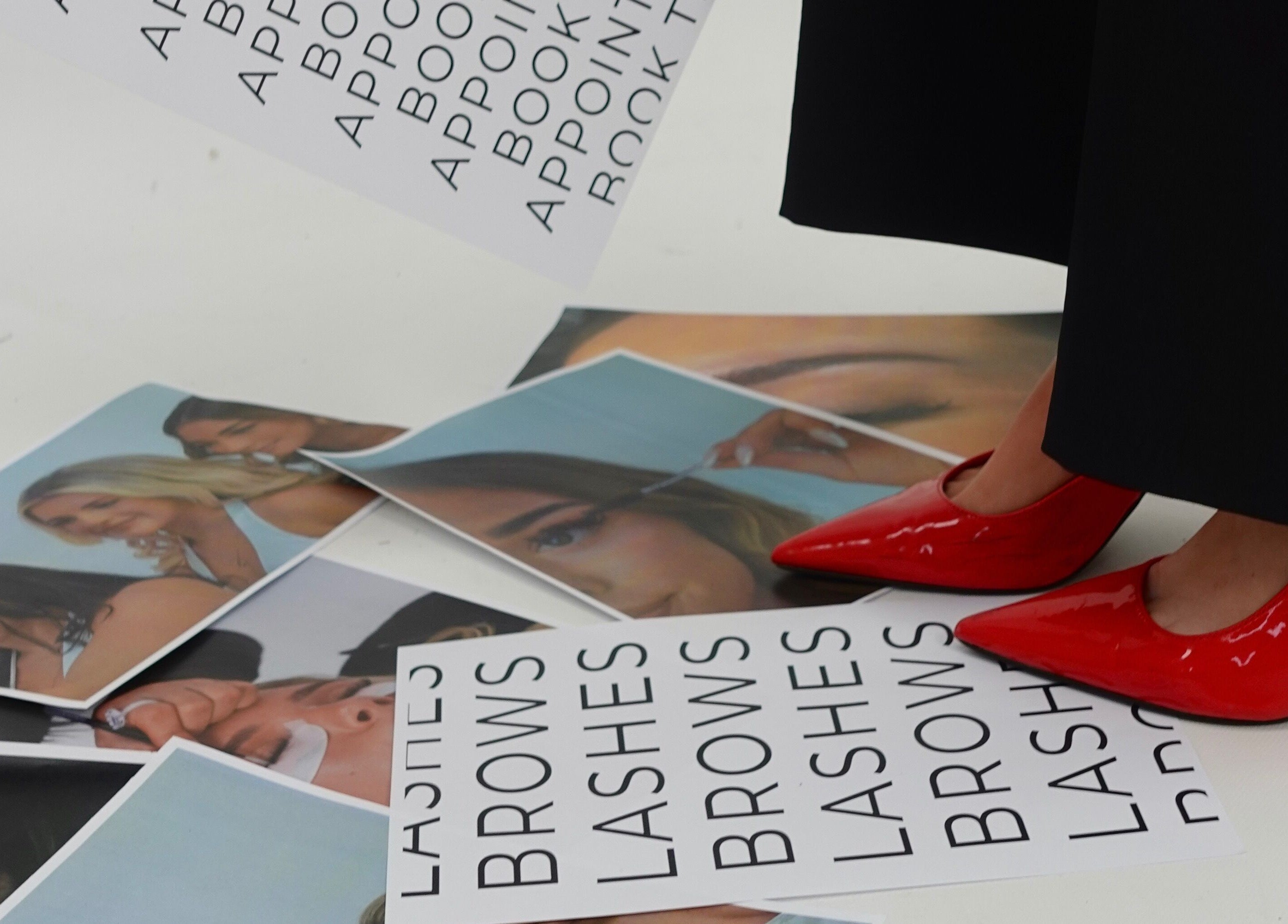 Red heels on Lash N Brow Lounge flyers at Melbourne, Victoria, AU, showcasing beauty services.