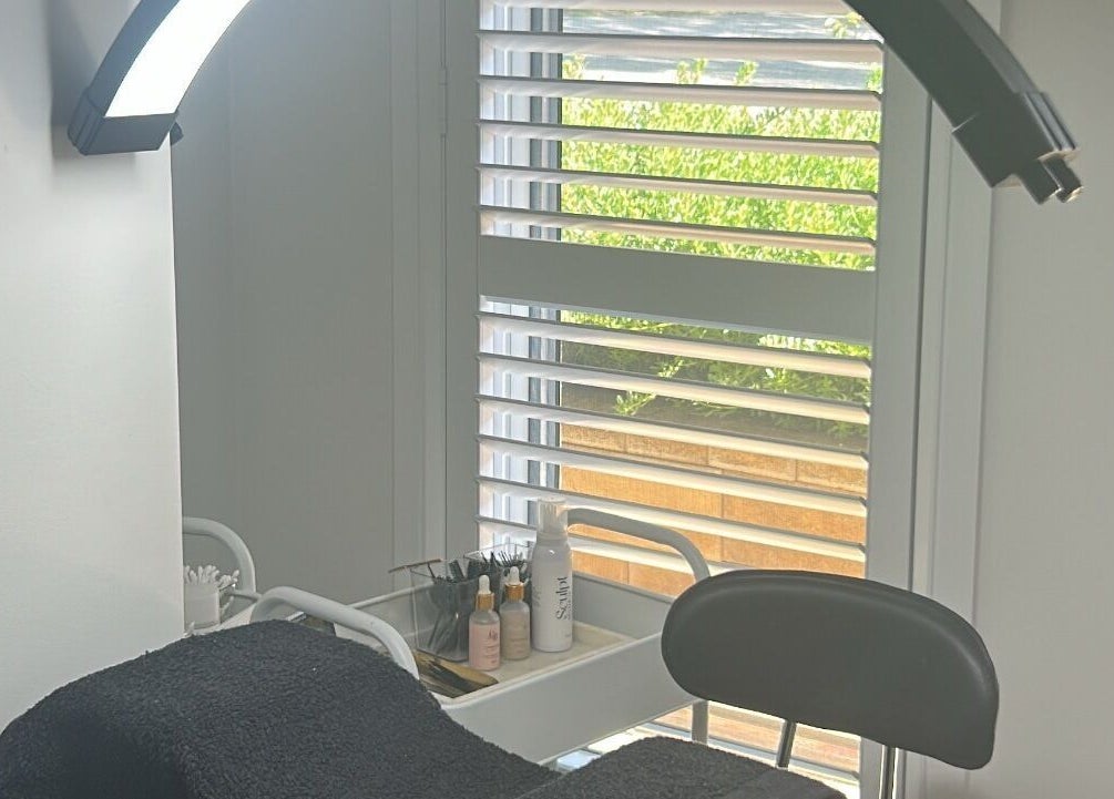 Cozy treatment room at Lash N Brow Lounge, Melbourne, Victoria, AU with a massage bed and beauty products.