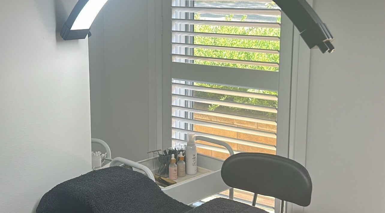 Cozy treatment area at Lash N Brow Lounge, Melbourne, Victoria, AU, with natural light and beauty products.