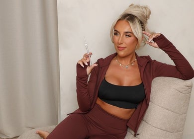 Relaxed client holding a syringe at Filled with Love Aesthetics in Coventry, England, GB, emphasizing beauty and wellness.