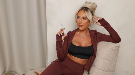 Relaxed client holding a syringe at Filled with Love Aesthetics in Coventry, England, GB, emphasizing beauty and wellness.