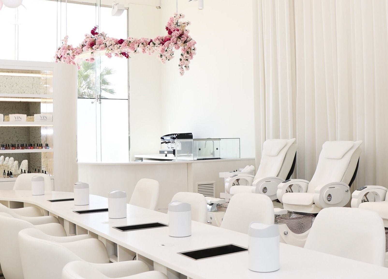 Elegant interior of Yin Salon and Spa in Riyadh, SA, featuring plush seating and floral décor.
