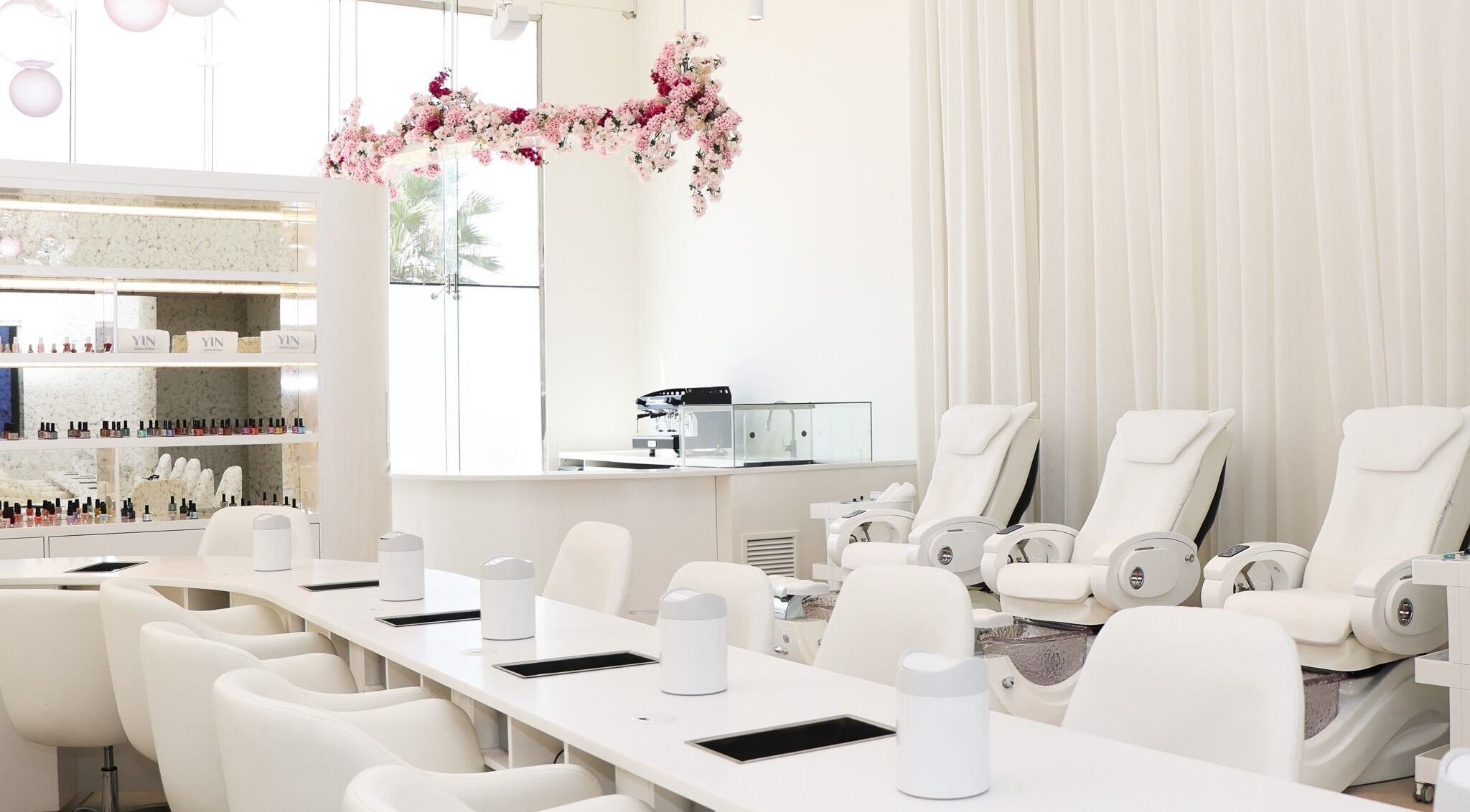 Elegant interior of Yin Salon and Spa in Riyadh, SA, featuring plush seating and floral décor.