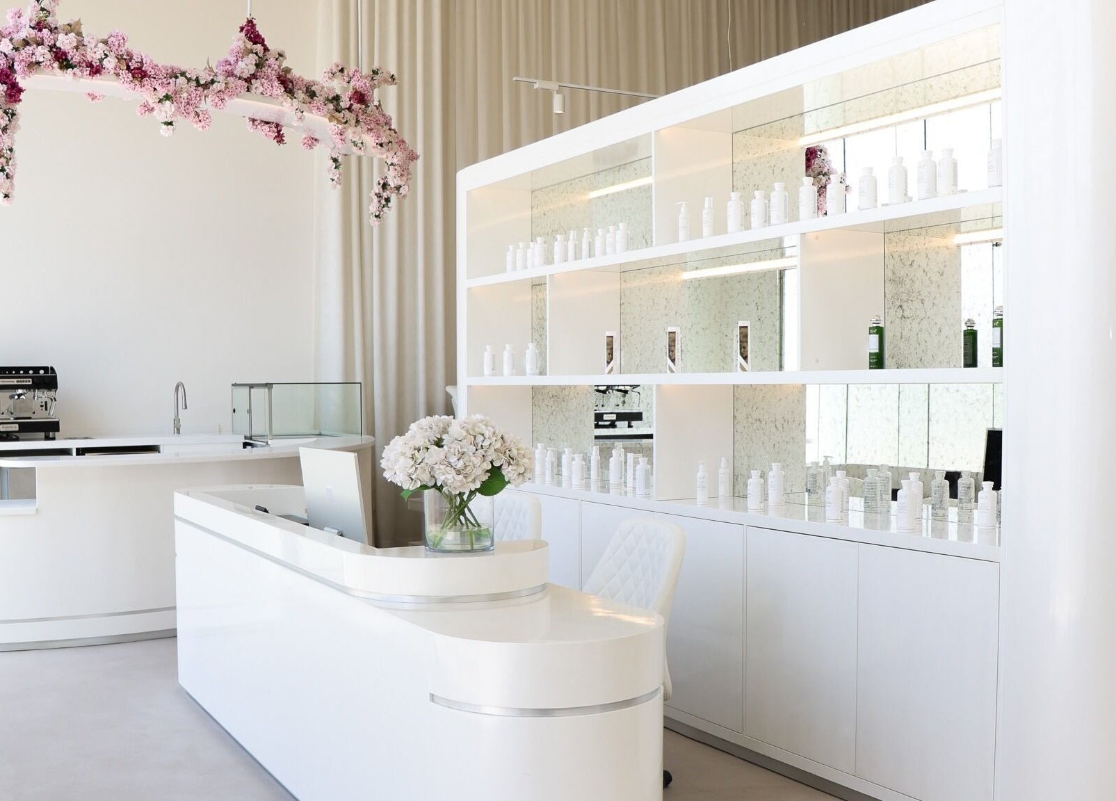 Bright and inviting reception at Yin Salon and Spa, Riyadh, SA, featuring elegant decor and floral accents.