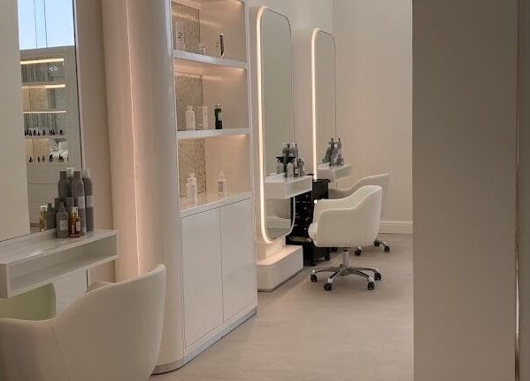 Chic styling stations at Yin Salon and Spa, Riyadh, SA, featuring modern white chairs and mirrors.
