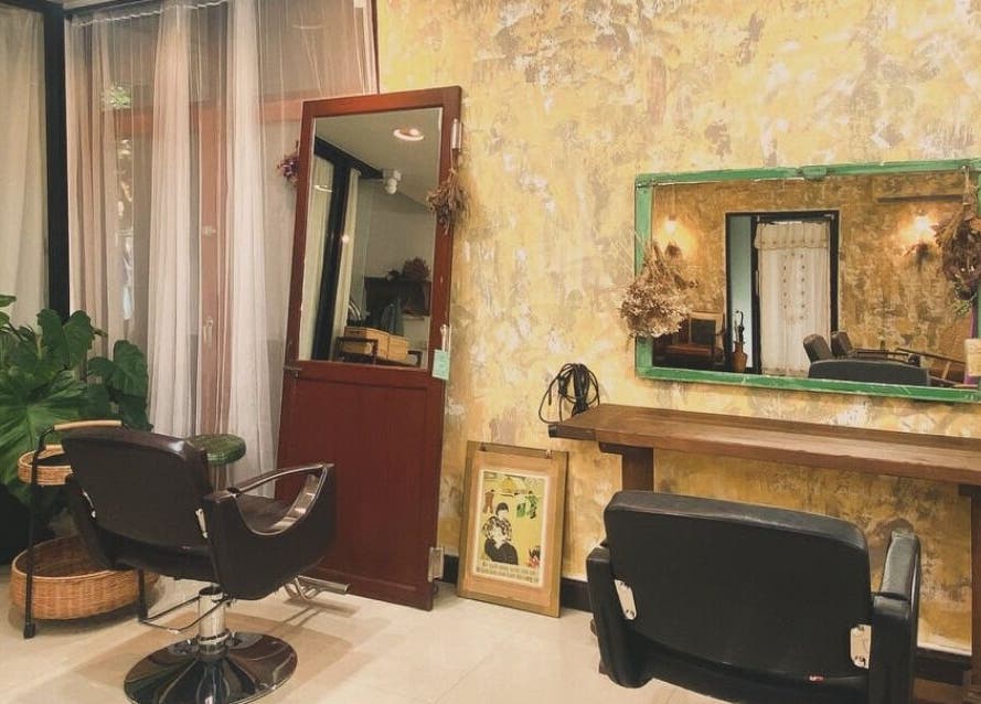 Elegant interior of CUCHU Hair Design in Bangkok, TH, featuring stylish décor and comfortable seating.
