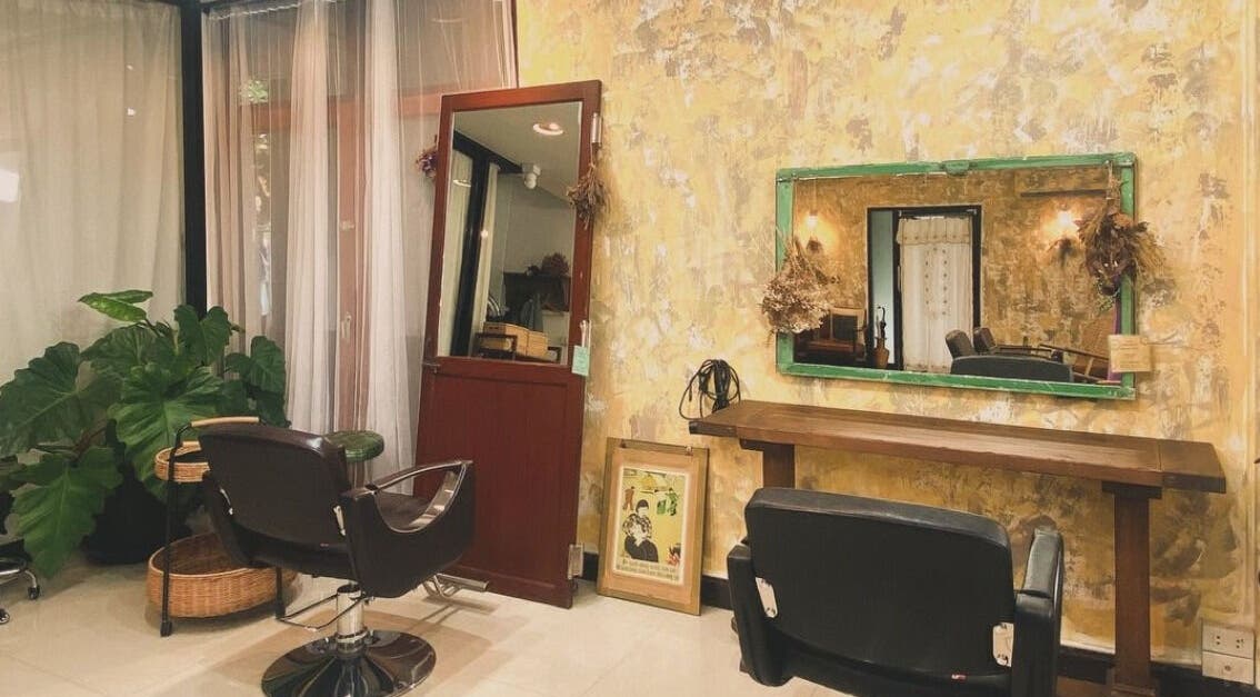 Elegant interior of CUCHU Hair Design in Bangkok, TH, featuring stylish décor and comfortable seating.