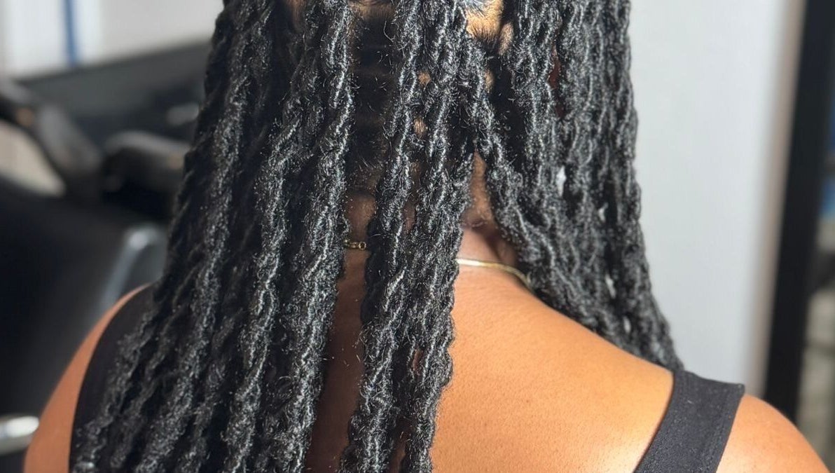 Intricate black locs styled at Loc’d In Hair Studio, St. Catherine, JM, showcasing expert craftsmanship.